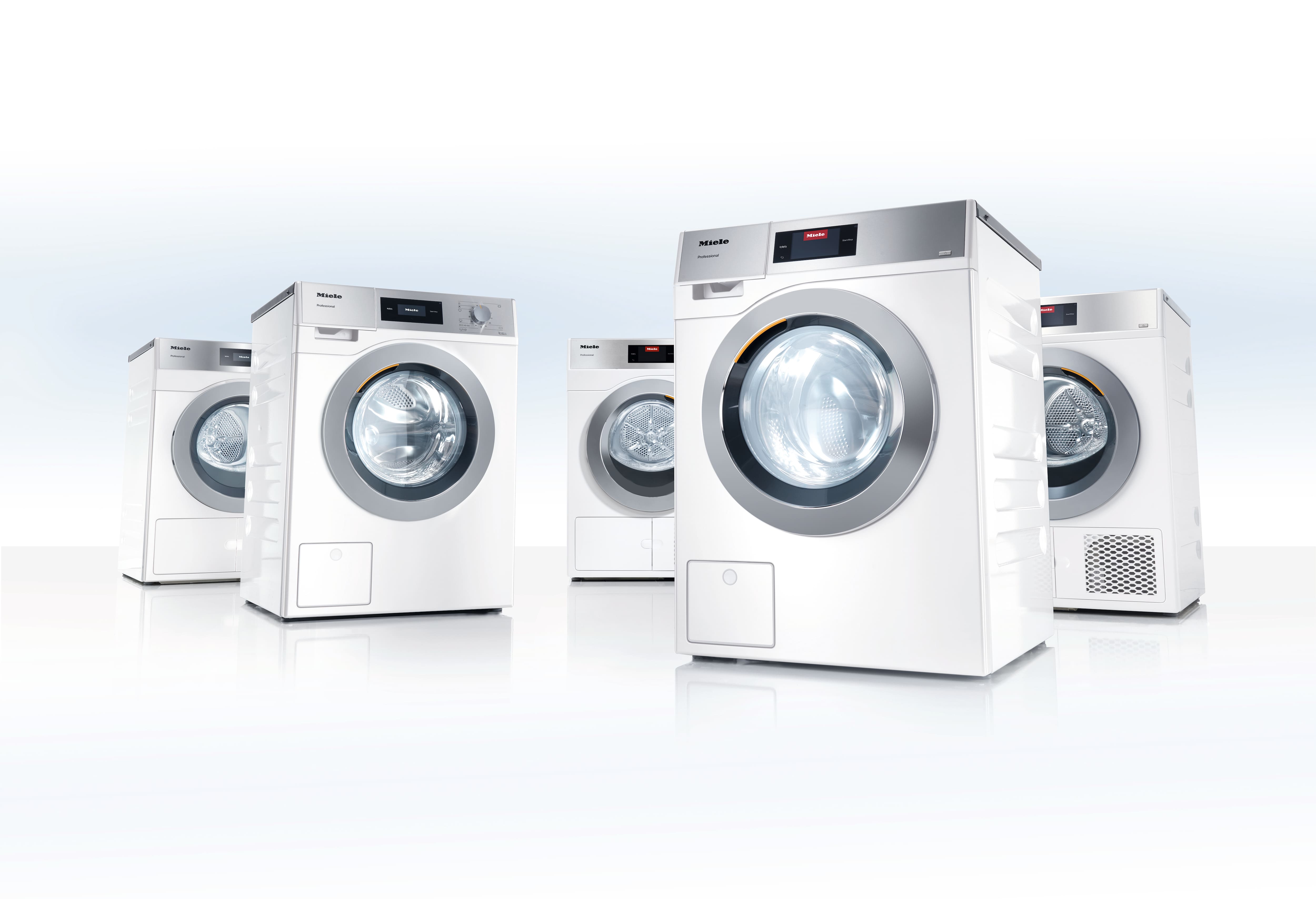 A white washing machine and tumble dryer in a laundry room in a concrete look.